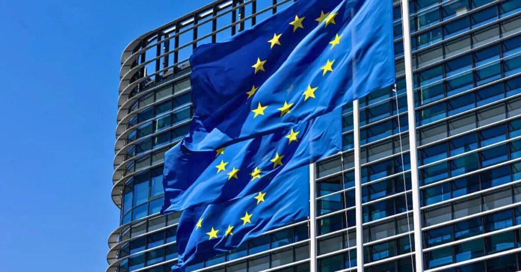 European Union flags wave in front of the European Parliament building as EU officials respond to Trump’s proposed 30 percent tariff.