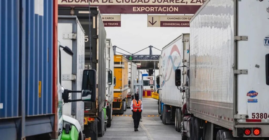 Cargo trucks lined up at a distribution site as businesses prepare for higher costs following Trump’s proposed tariff plan.