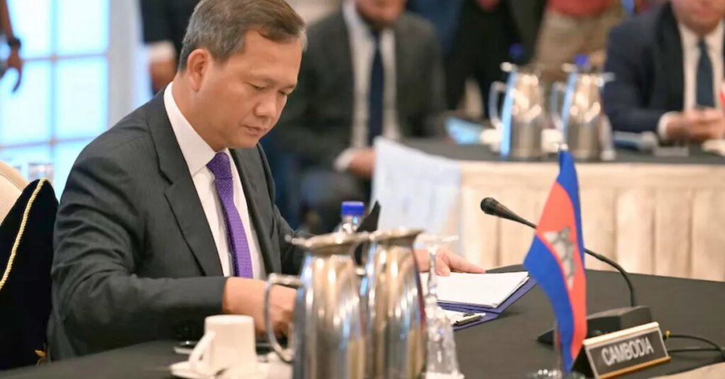 Cambodian official reviews documents during ASEAN ceasefire negotiations with Thailand in July 2025.