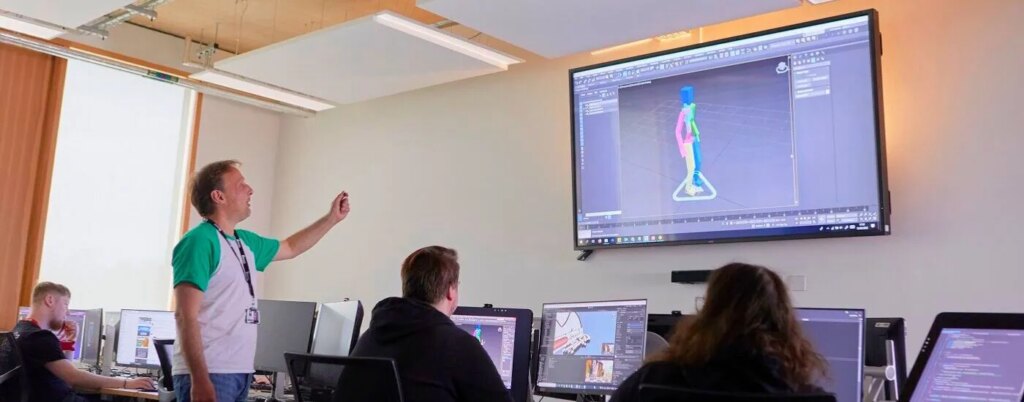 Computer science students attending interactive seminar in modern University of Northampton classroom